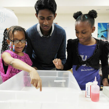 Older kids doing science experiment