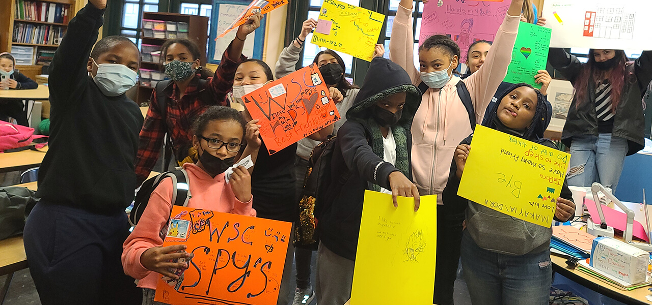 Kids holding WSC signs