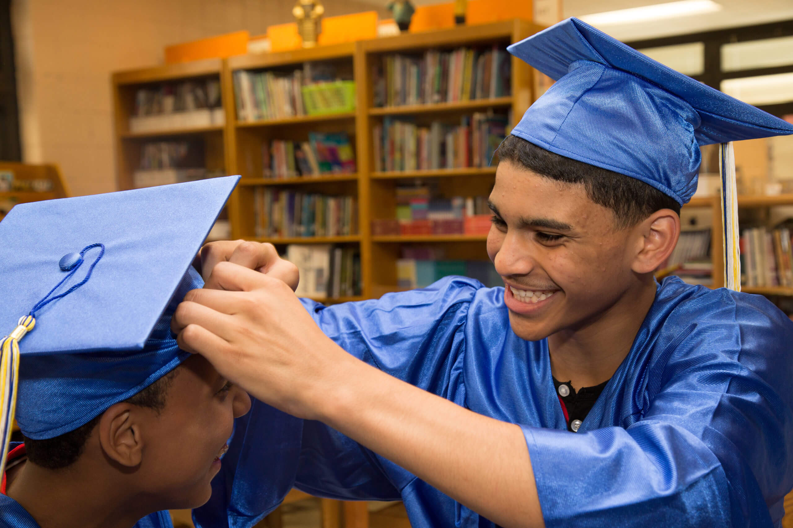 Teens in graduation caps and gowns