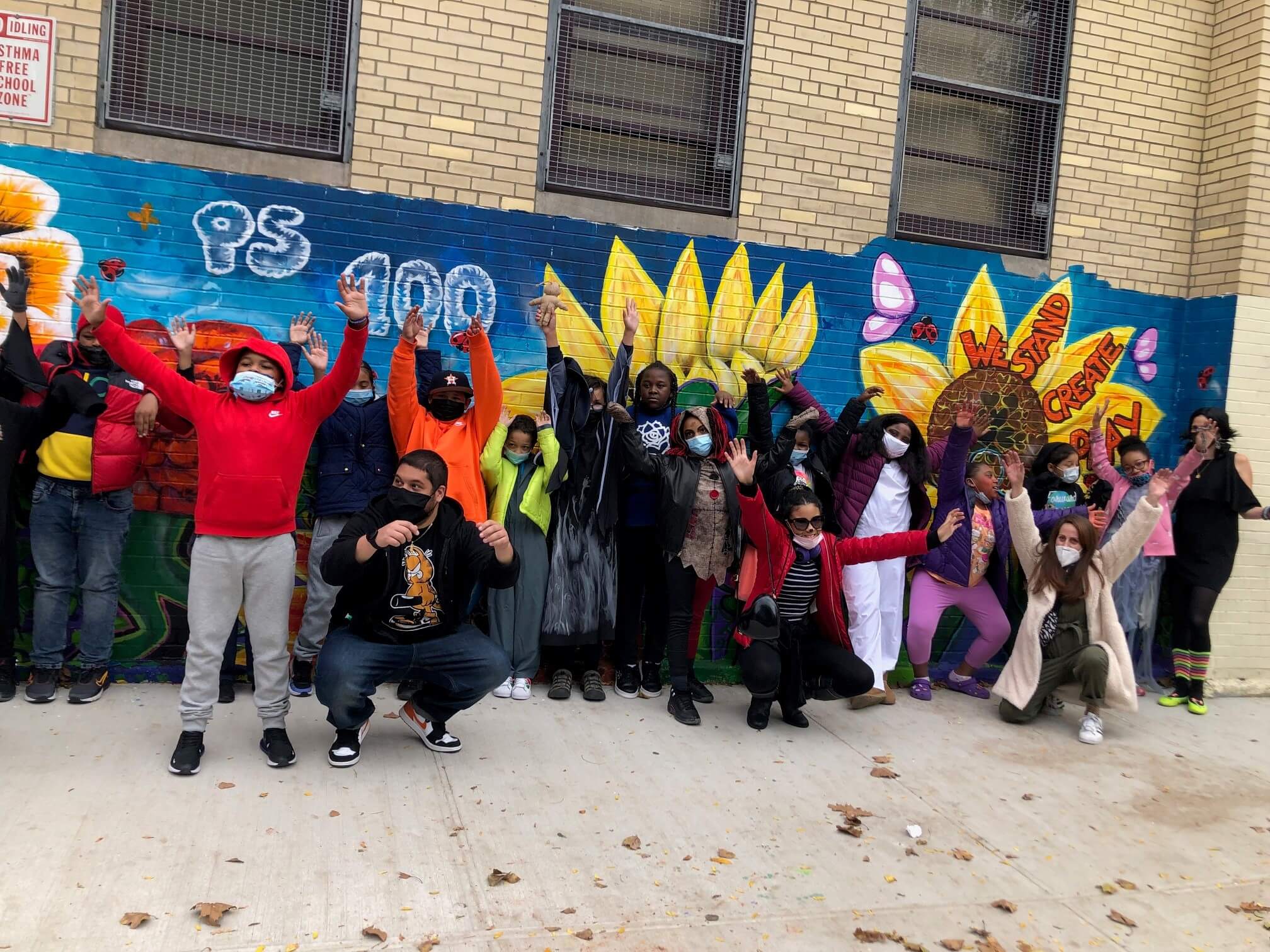 Kids in front of colorful mural