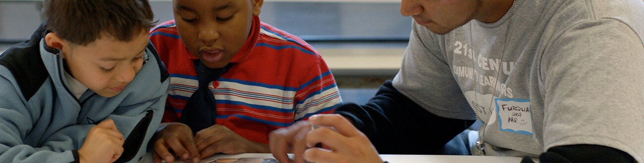 Young kids with reading mentor